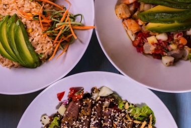 Three flavorful dishes featuring seafood and avocado, plated creatively for a delightful meal.